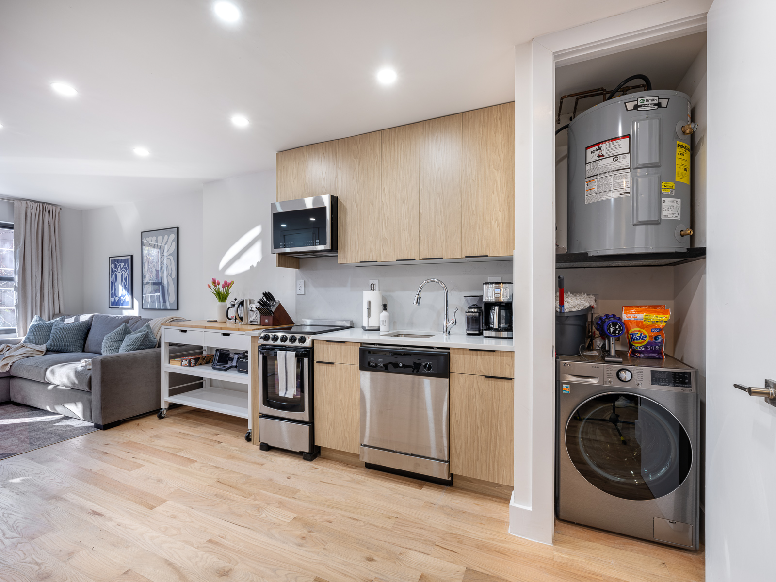 Kitchen with in-unit washer/dryer and storage