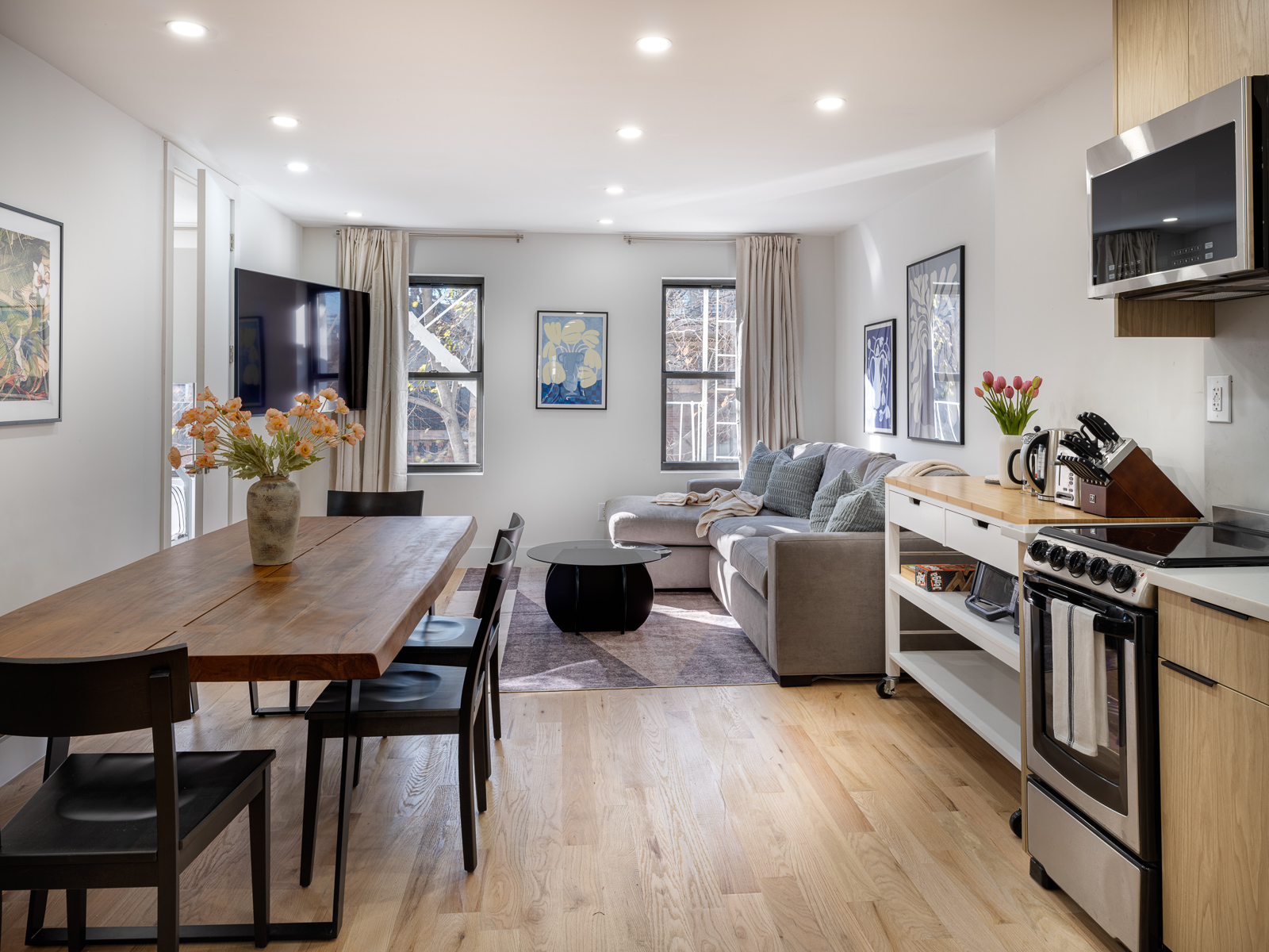 Open living and dining area with live-edge table and gray sectional