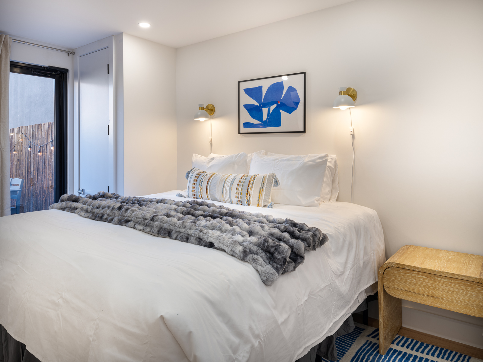King bedroom with curtains opening to a private terrace