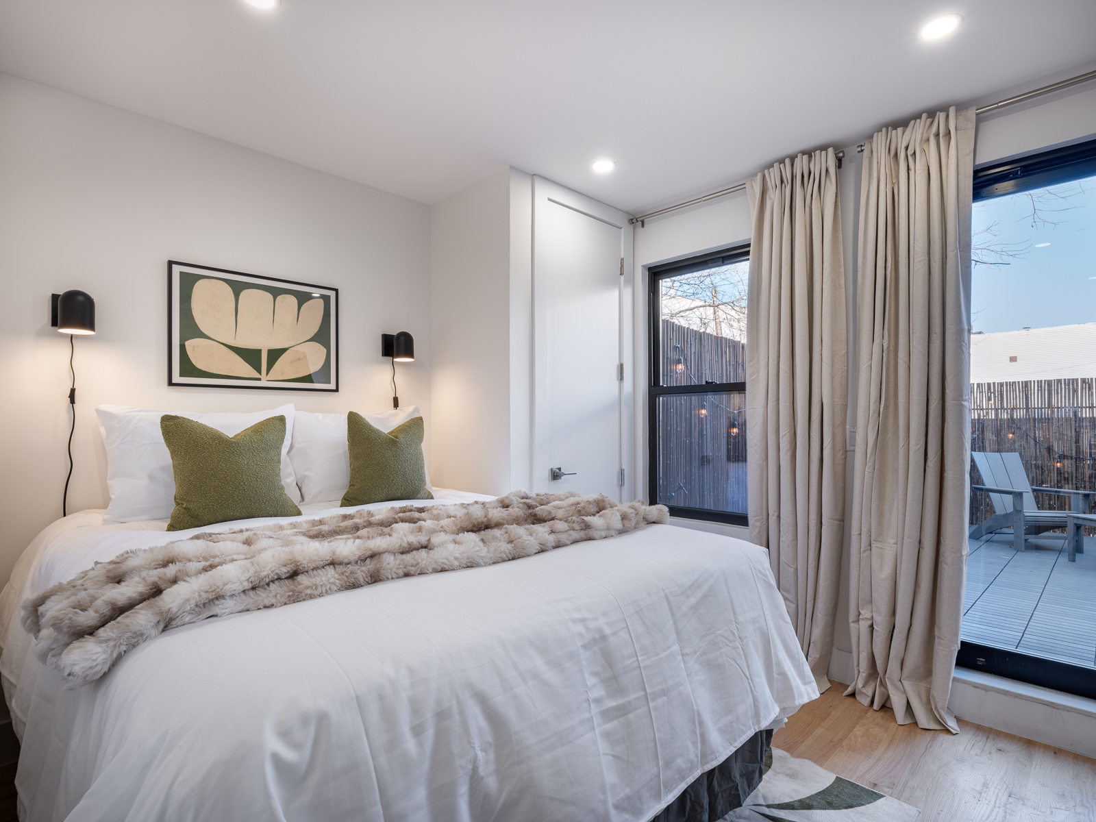 Serene king bedroom with art and bedside sconces